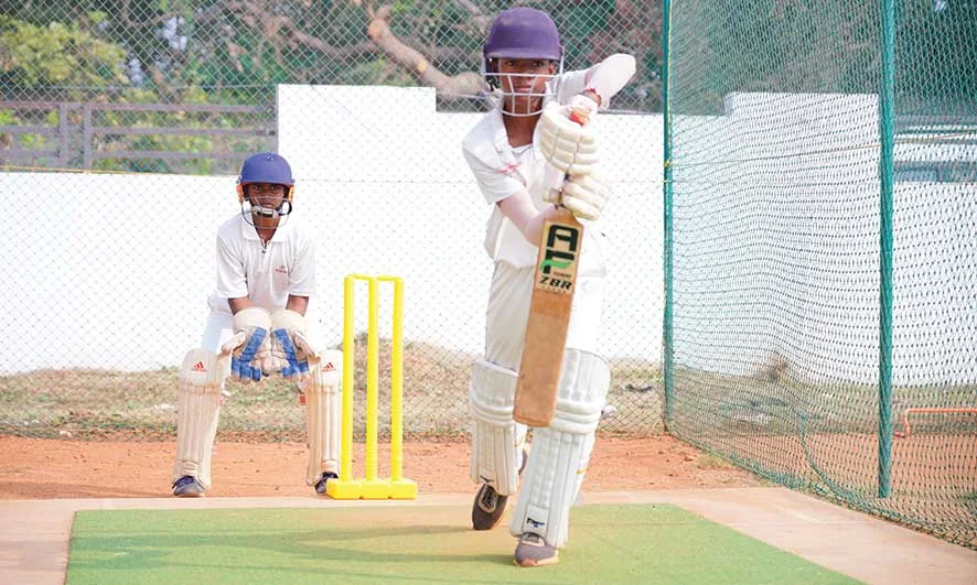 Students participating in cricket training