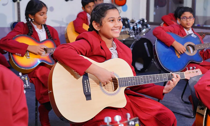 Students practising music with guitars